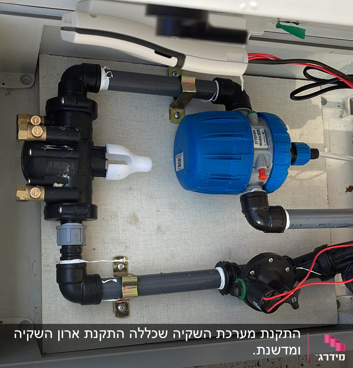 מערכת השקיה עם צינורות, שסתומים ומשאבה כחולה